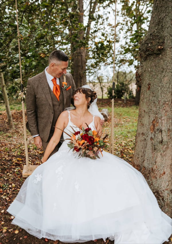 Bride and groom with wedding flowers by B's Blooms