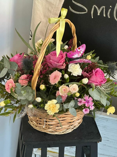 Butterfly Garden Basket - A charming basket arrangement featuring fresh seasonal flowers in soft pink, cream and burgundy tones, beautifully arranged to create a thoughtful gift, with flowers dependent on seasonal availability.