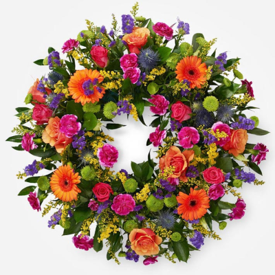 Remembrance Wreath - A colourful wreath featuring bright seasonal flowers, thoughtfully arranged to celebrate a vibrant and cherished life.