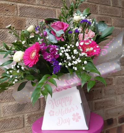 Pink Celebration - A vibrant front-facing bouquet filled with bold pinks, rich purples and delicate white accents, finished with fresh greenery.