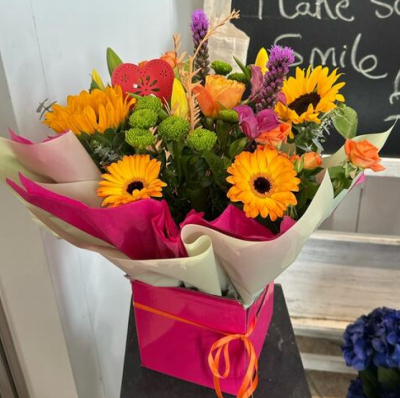 Bright Spark - A joyful bouquet bursting with bright yellow, orange, pink and purple tones for a wonderfully uplifting display.